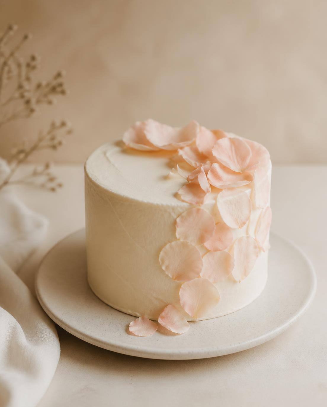Small single-tier cake with blush petals